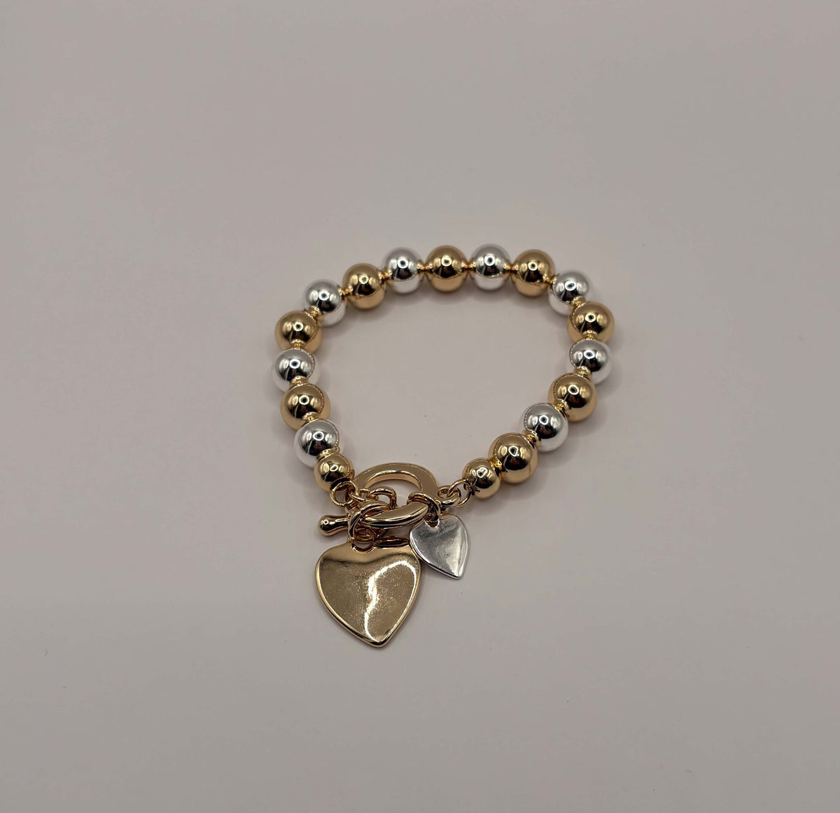Elastische statement armband hart goud- en zilverkleurig