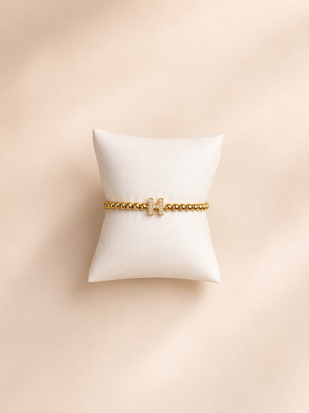 Elastisch H armbandje goud
