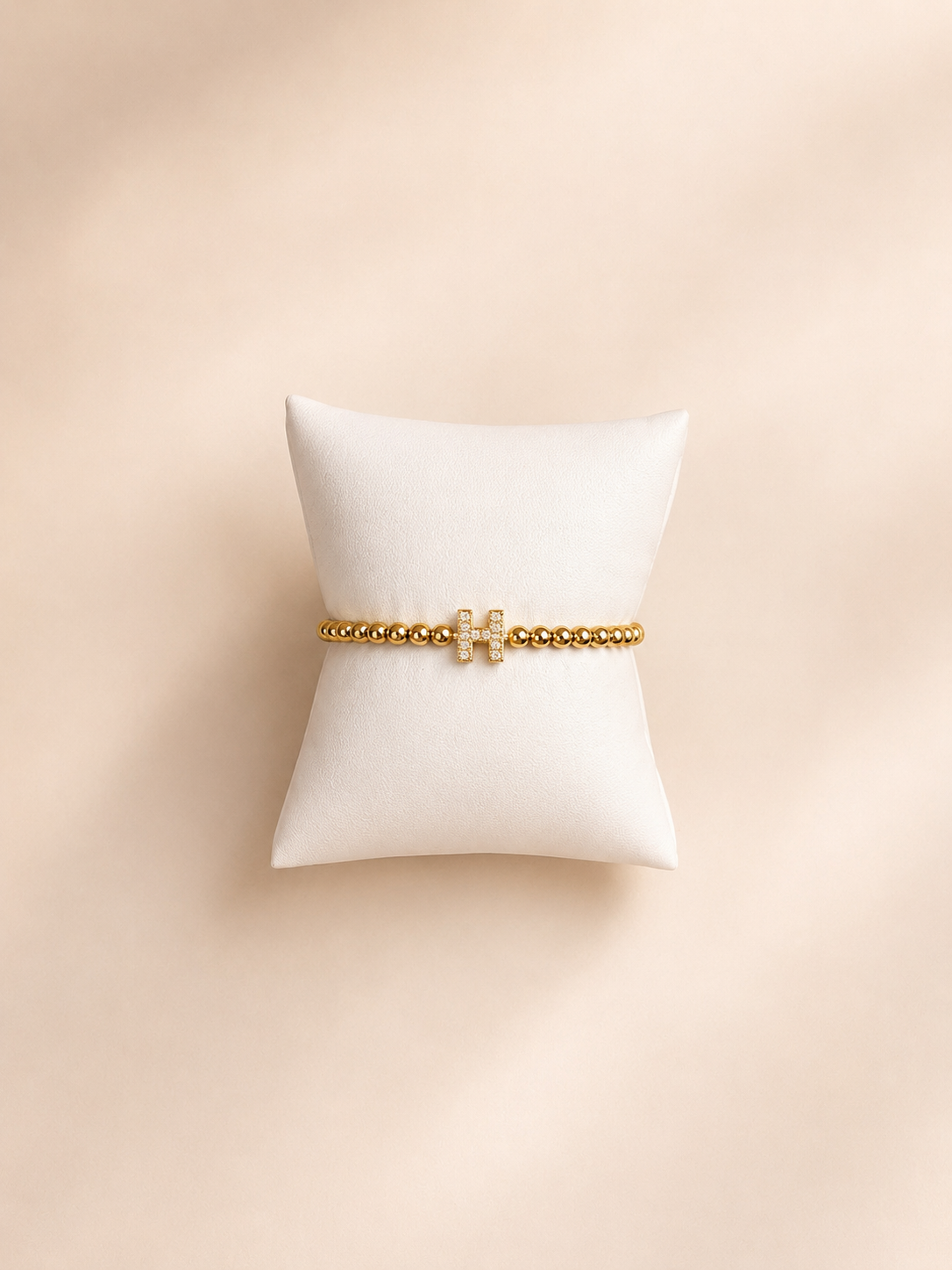 Elastisch H armbandje goud