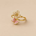 Ring met vlinder en bloem roze goud